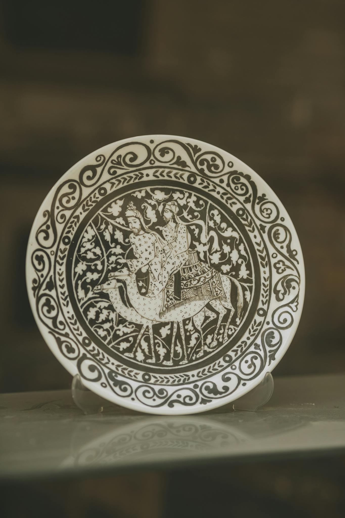 Decorative plate with elaborate patterns and figures, a perfect art piece.