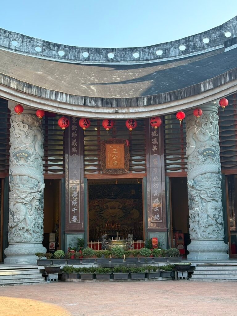 Main shrine entrance framed by carved stone dragon columns