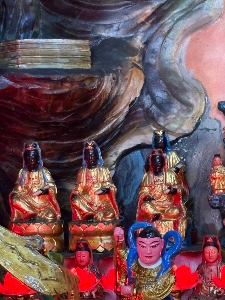 Black-faced Guanyin figures displayed inside Cian Temple