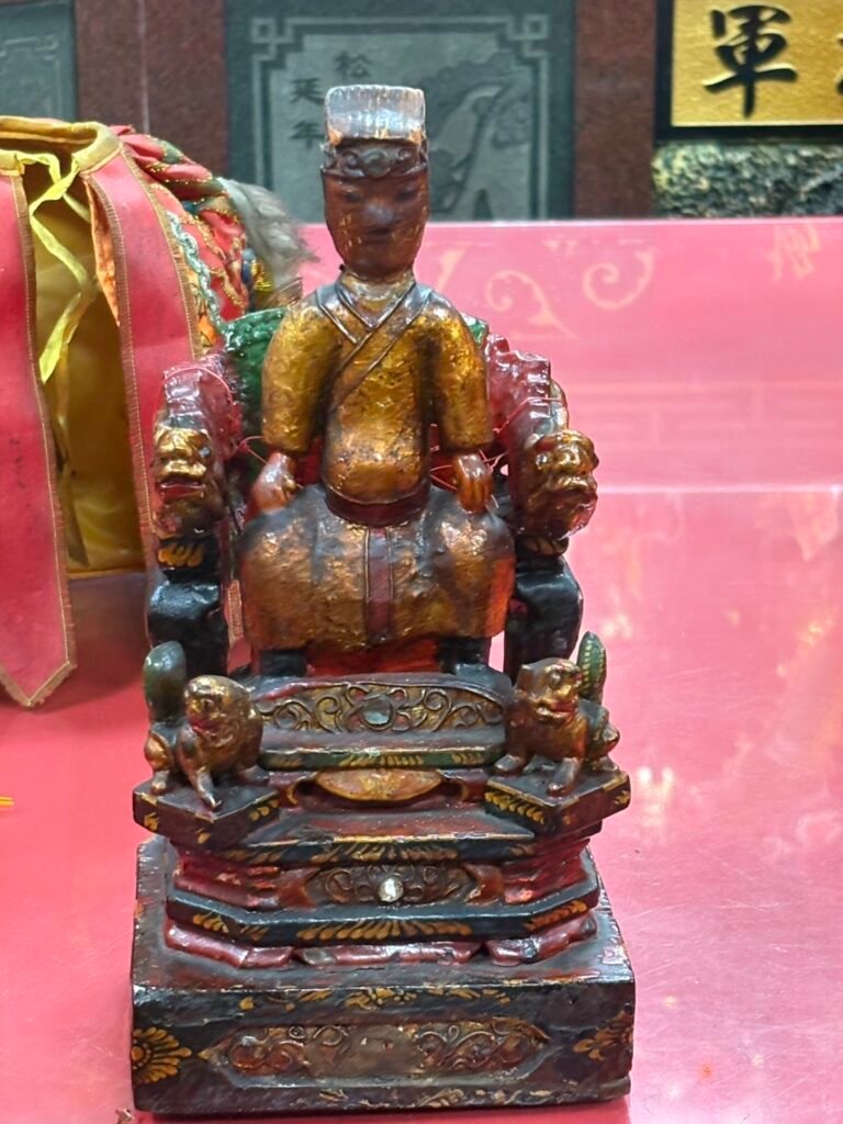 Front view of the seated wooden Imperial Scholar statue