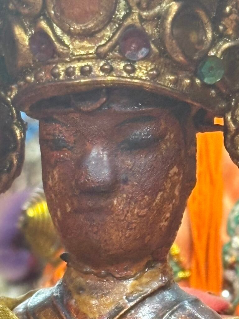 Close view of the weathered face of the Xiucai Ye statue
